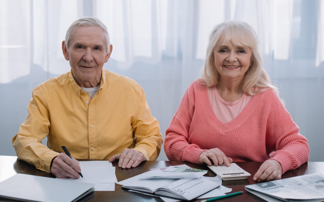 Senior couple planning their finances for an assisted living